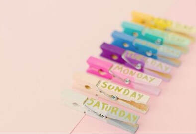 Clothes pins with the days of the week written on them in different colors.