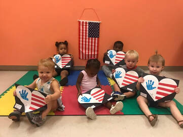 Students paint heart shaped American flags for Memorial Day  at their daycare, Fort Myers FL