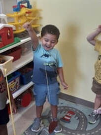 Student pretends to fish with the class at his daycare, Fort Myers